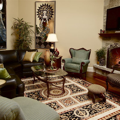 Family room - eclectic dark wood floor family room idea in Chicago with beige walls, a standard fireplace, a stone fireplace and a wall-mounted tv