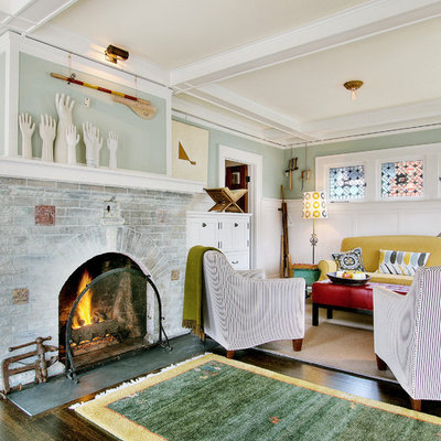 Inspiration for an eclectic dark wood floor family room remodel in Seattle with blue walls, a standard fireplace, a brick fireplace and no tv