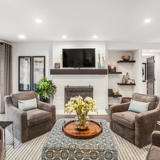 Trendy open concept medium tone wood floor and brown floor family room photo in Grand Rapids with white walls, a wood stove, a brick fireplace and a wall-mounted tv