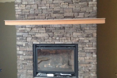 Inspiration for a mid-sized family room remodel in Other with green walls, a standard fireplace and a concrete fireplace