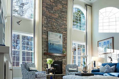 Inspiration for a large traditional open plan games room in Raleigh with grey walls, dark hardwood flooring, a standard fireplace, a stone fireplace surround, a wall mounted tv and brown floors.