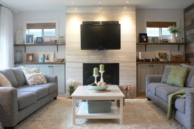 Example of a mid-sized minimalist open concept light wood floor family room design in Vancouver with white walls, a standard fireplace, a tile fireplace and a wall-mounted tv