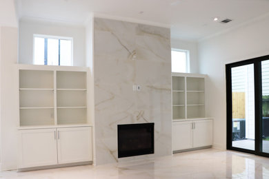 Example of a large minimalist open concept porcelain tile family room design in Houston with white walls, a standard fireplace, a tile fireplace and a wall-mounted tv