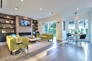 Mid-sized transitional open concept gray floor and light wood floor family room photo in Los Angeles with white walls, a ribbon fireplace, a wall-mounted tv and a concrete fireplace