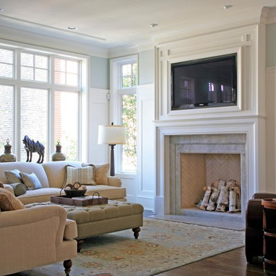 Mid-sized elegant open concept medium tone wood floor and brown floor family room photo in Chicago with gray walls, a standard fireplace, a tile fireplace and a media wall