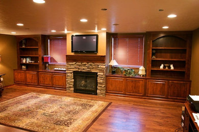 Large family room photo in Other with a standard fireplace, a stone fireplace and a wall-mounted tv