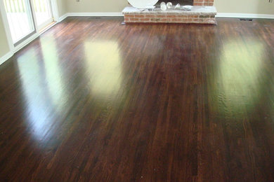 Large medium tone wood floor family room photo in New York