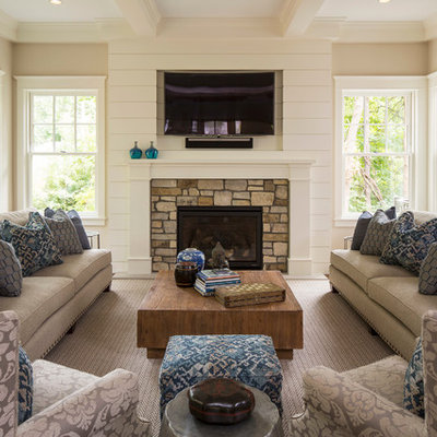 Inspiration for a timeless family room remodel in Minneapolis with beige walls, a standard fireplace, a stone fireplace and a wall-mounted tv
