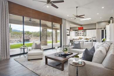 Example of a large country open concept porcelain tile and gray floor family room design in Phoenix with gray walls, a corner fireplace, a stone fireplace and a wall-mounted tv