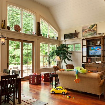 Family room - mid-sized rustic open concept medium tone wood floor and brown floor family room idea in Nashville with beige walls, no fireplace and a wall-mounted tv