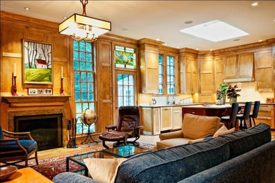 Large elegant medium tone wood floor family room photo in Nashville with beige walls, a standard fireplace and a stone fireplace