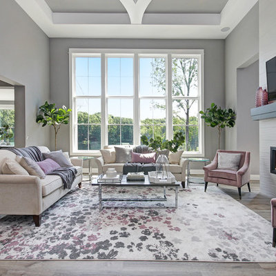 Transitional open concept light wood floor family room photo in Grand Rapids with gray walls, a ribbon fireplace, a tile fireplace and a wall-mounted tv