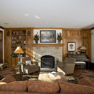 Family Room Featuring Knotty Cherry Wall Paneling and Stone Fireplace Surround