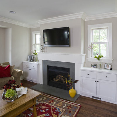 Example of a mid-sized mountain style open concept medium tone wood floor and brown floor family room design in Chicago with beige walls, a standard fireplace, a wall-mounted tv and a concrete fireplace