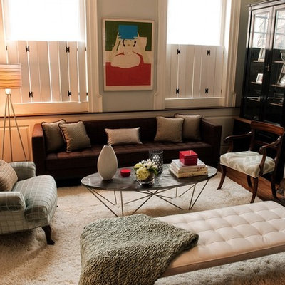 Example of an eclectic medium tone wood floor family room design in Philadelphia with beige walls, a standard fireplace and a stone fireplace