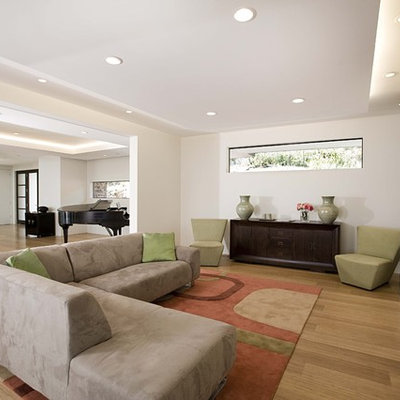 Inspiration for a contemporary open concept bamboo floor family room remodel in San Francisco with white walls and a standard fireplace