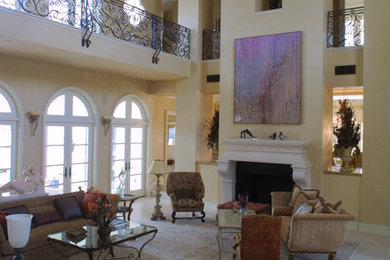 Inspiration for a huge timeless open concept family room remodel in Houston with beige walls, a standard fireplace and a plaster fireplace