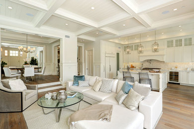 Large transitional open concept medium tone wood floor family room photo in Los Angeles with white walls, a standard fireplace, no tv and a wood fireplace surround