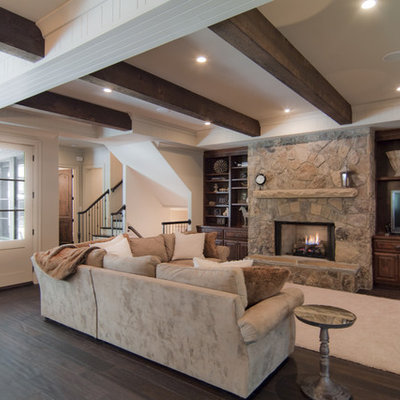 Example of a mid-sized classic open concept medium tone wood floor and brown floor family room design in Charlotte with white walls, a standard fireplace, a stone fireplace and a tv stand