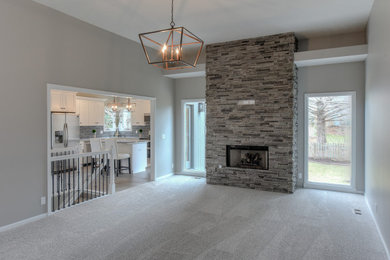 Transitional open concept family room photo in Omaha with a wall-mounted tv
