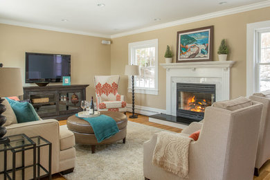 Example of a transitional enclosed light wood floor family room design in Boston with beige walls, a standard fireplace and a stone fireplace