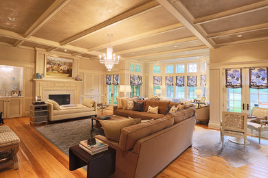 Large elegant enclosed medium tone wood floor family room photo in Chicago with beige walls, a standard fireplace, a tile fireplace and a wall-mounted tv