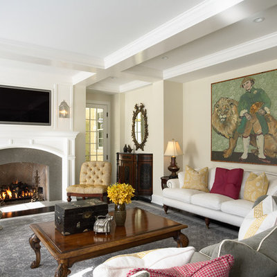 Family room - mid-sized traditional enclosed family room idea in Minneapolis with beige walls, a standard fireplace, a wall-mounted tv and a stone fireplace