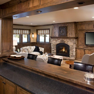 Family room - rustic family room idea in Minneapolis with a stone fireplace