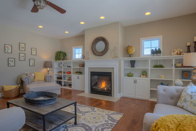 Example of a large transitional open concept medium tone wood floor family room design with beige walls, a standard fireplace and a stone fireplace