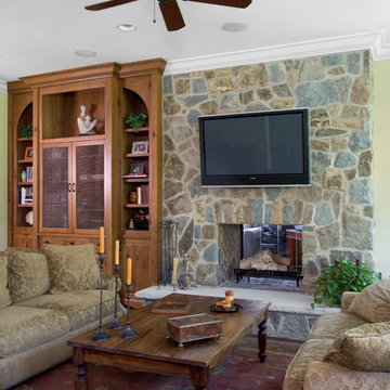 Family Room with Floor to Ceiling Knotty Pine Built in and Stone Fireplace