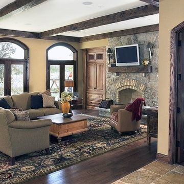 Family Room with Floor to Ceiling Stone Fireplace and Custom Built In