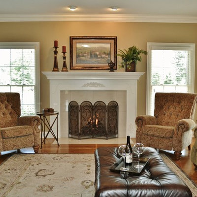 Inspiration for a timeless medium tone wood floor family room remodel in Chicago with beige walls and a standard fireplace