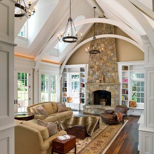 Elegant dark wood floor family room photo in Boston with beige walls, a standard fireplace and a stone fireplace