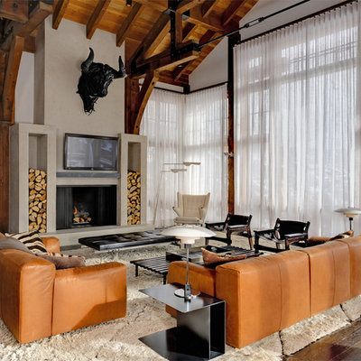 Mountain style open concept dark wood floor family room photo in New York with beige walls, a standard fireplace and a wall-mounted tv