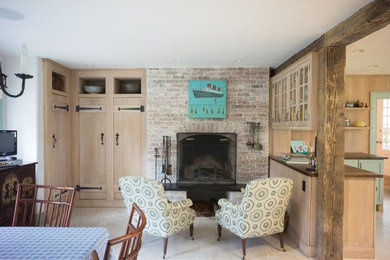 Inspiration for a mid-sized farmhouse enclosed light wood floor and beige floor family room remodel in New York with beige walls, a standard fireplace and a brick fireplace