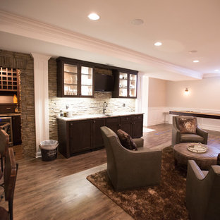 Large transitional open concept family room in Chicago with vinyl floors, a game room, beige walls, no fireplace, a built-in media wall and brown floor.