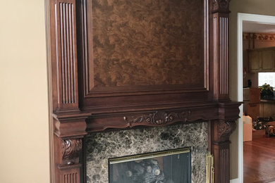 This is an example of a large classic games room in Chicago with a standard fireplace and a wooden fireplace surround.