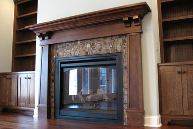 Family room - traditional family room idea in Other with a tile fireplace