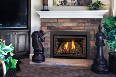 Example of a mid-sized transitional open concept dark wood floor and beige floor family room design in Kansas City with white walls, a corner fireplace, a brick fireplace and a media wall