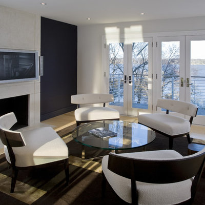 Family room - contemporary light wood floor family room idea in DC Metro with black walls, a standard fireplace and a wall-mounted tv