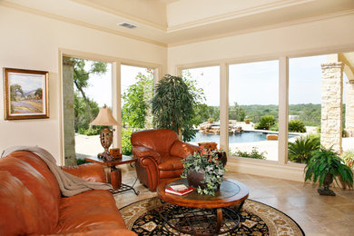 Mid-sized elegant enclosed travertine floor family room photo in Austin with white walls