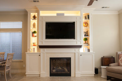 Example of a mid-sized classic ceramic tile family room design in Other with beige walls, a standard fireplace, a stone fireplace and a media wall