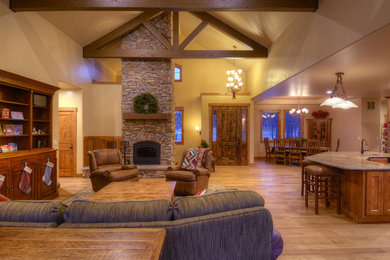 Example of a transitional open concept light wood floor family room design in Denver with beige walls, a standard fireplace and a stone fireplace