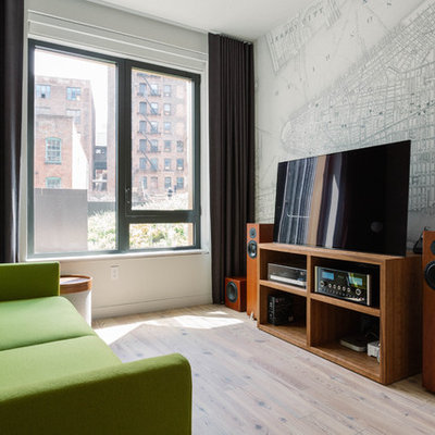 Example of a large trendy enclosed light wood floor and beige floor family room design in New York with a music area, white walls and a tv stand