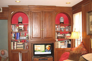 Family room photo in New Orleans with red walls, no fireplace and a media wall