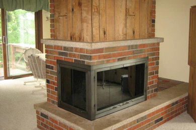 Inspiration for a family room remodel in Other with a two-sided fireplace and a brick fireplace