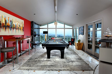 Example of a mid-sized trendy enclosed marble floor game room design in San Francisco with red walls, a standard fireplace, a stone fireplace and no tv