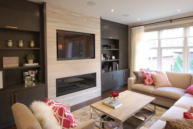Family room - mid-sized transitional open concept dark wood floor family room idea in Toronto with beige walls, a media wall, a ribbon fireplace and a stone fireplace