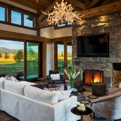 Large mountain style open concept dark wood floor and brown floor family room photo in Other with white walls, a standard fireplace, a stone fireplace and a wall-mounted tv