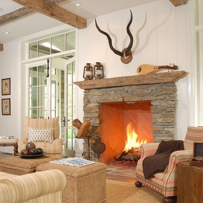 Mountain style family room photo in Los Angeles with white walls, a standard fireplace and a stone fireplace